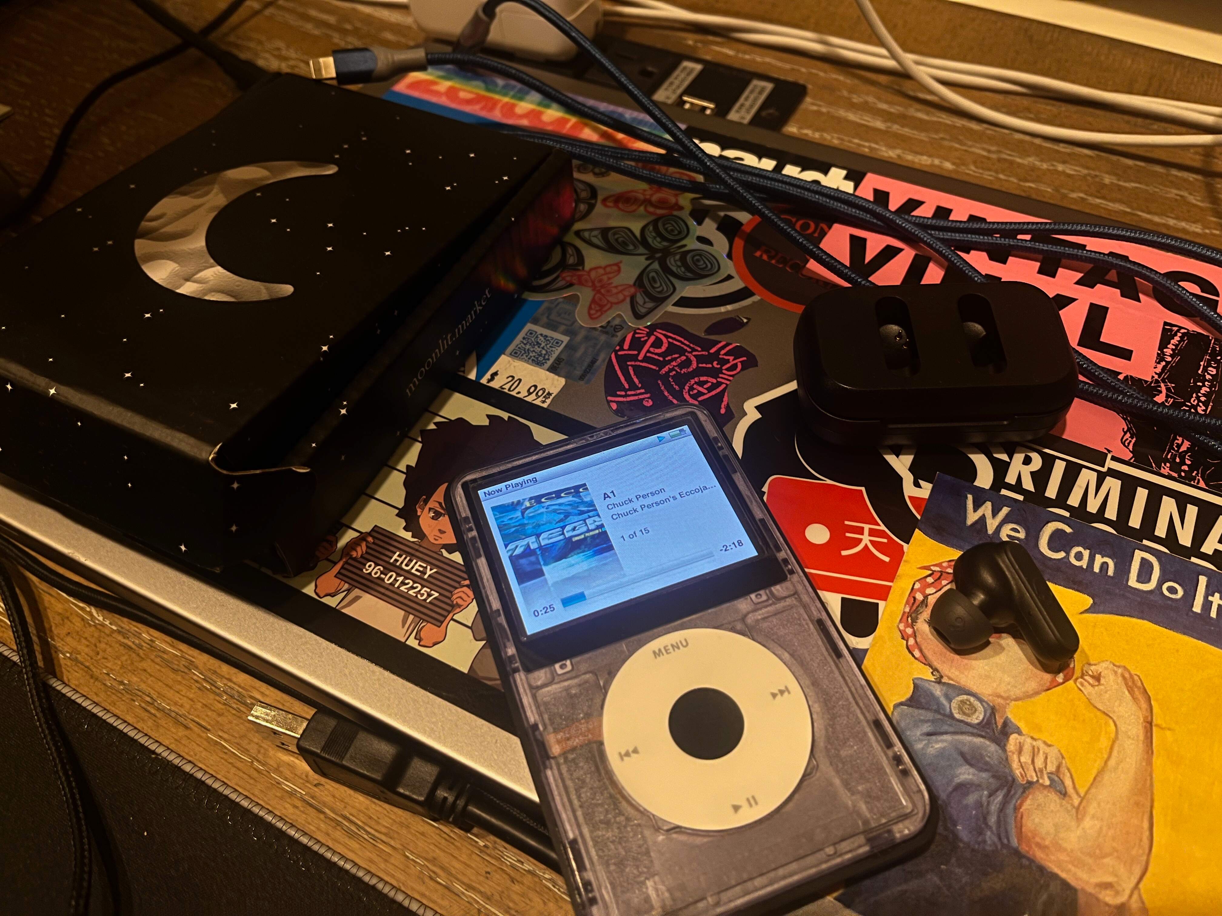image of ipod on close to modkit box with bluetooth earbuds by it.